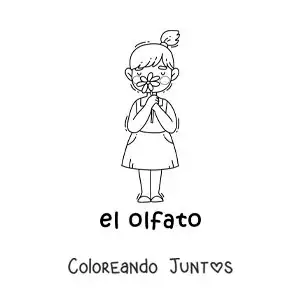 Una niña usando el sentido del olfato para oler una flor