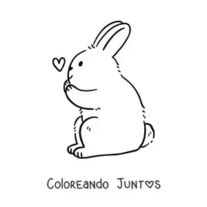 Imagen para colorear de un conejo sentado de perfil con un corazón pequeño en el aire